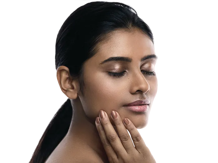 A woman with her eyes closed and one hand at her jaw, lit low and warm.